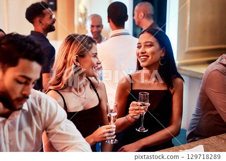 Friends, party and alcohol drink, champagne and event at restaurant, happy smile and crowd conversation at night. People talking, drinking and happiness at club together talking, fun and social 129718289