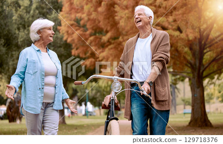 Elderly, couple and bike in the park for nature walk and exercise outdoor, senior man laugh at funny joke with old woman and eco friendly travel. Walking, cycling bicycle and retirement in New York. 129718376