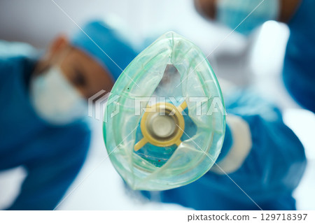 Closeup oxygen mask, ventilation and doctors in hospital of emergency healthcare, surgery or medicine in operating room. Breathing machine, ventilator and air for patient, lungs and medical operation 129718397
