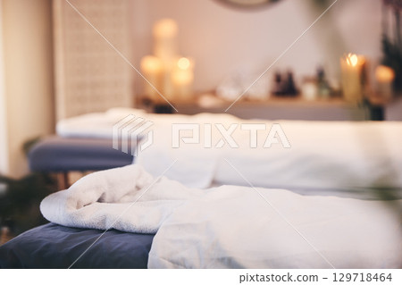 Spa, massage bed and blurred background with candles, bokeh and room for health, wellness and treatment. Physical therapy table, luxury resort or beauty salon for body care, relax or peace in Bangkok 129718464