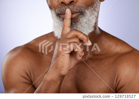 Senior man, skincare secret and face beauty in purple studio for luxury wellness, salon cosmetic care and black man dermatology. Elderly African person, finger on lips and natural facial or body care 129718527
