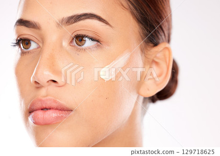 Woman, face and beauty cream for sunscreen makeup product, luxury facial treatment or shine on studio background. Young model, cheek lotion and wellness cosmetics, healthy skincare and aesthetic glow 129718625
