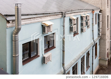 Air conditioners are installed on facade of building. device for comfortable living in hot weather. Air conditioners are installed on facade of building. device for comfortable living in hot weather. 129718806