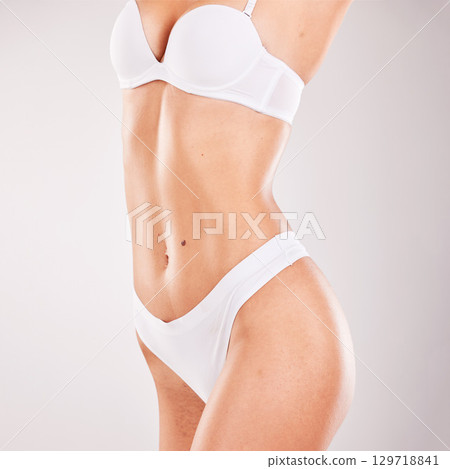 Lingerie, healthy body and woman in studio with lose weight results, fitness and beauty aesthetic on white background promotion. Underwear, skincare and sexy woman or model gut health and stomach Lingerie, healthy body and woman in studio with lose weight results, fitness and beauty aesthetic on white background promotion. Underwear, skincare and sexy woman or model gut health and stomach 129718841