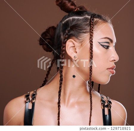 Punk, fashion and woman with creative cosmetics, hair style and makeup in brown studio background. Young female, hipster and 90s style, face and bondge clothes with rock aesthetic and gen z girl 129718921