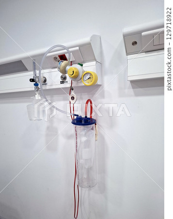 Emergency hospital room in Spain shows an oxygen supply system and infusion drip. Essential medical equipment is ready for patient care during critical situations. 129718922