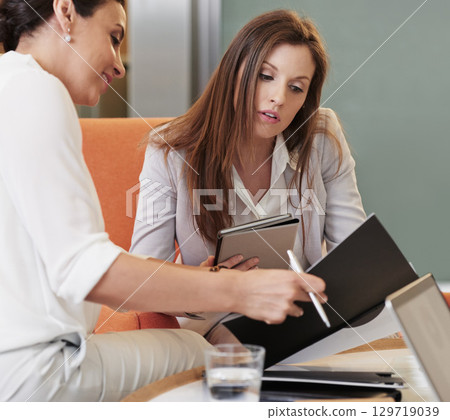 Teamwork, documents and tablet with business women talking in meeting, notebook and strategy. Collaboration, idea and female workers in conversation looking at report, paperwork and planning project 129719039