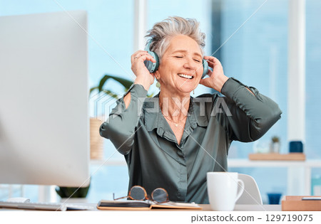 Office music, relax and business woman with audio headphones, podcast and streaming radio in an office at work. Worker freedom, corporate smile and senior employee listening to a song on company wifi 129719075