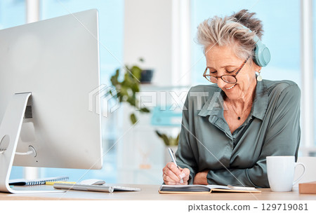 Senior woman, headphones and writing in office or happy planning motivation with notebook and music. Elderly person, smile and business happiness, employee working or relax with online podcast Senior woman, headphones and writing in office or happy planning motivation with notebook and music. Elderly person, smile and business happiness, employee working or relax with online podcast 129719081