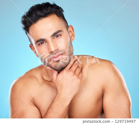 Beauty, skincare and grooming with portrait of man for facial, wellness and luxury. Product, cosmetics and cleaning with face of model for glow, beard routine and self care in blue background studio Beauty, skincare and grooming with portrait of man for facial, wellness and luxury. Product, cosmetics and cleaning with face of model for glow, beard routine and self care in blue background studio 129719497