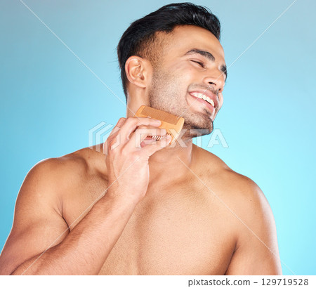 Beauty, brush and man comb beard for facial hair care maintenance, self care grooming or daily wellness treatment. Spa salon, healthcare and model with combing product isolated on blue background Beauty, brush and man comb beard for facial hair care maintenance, self care grooming or daily wellness treatment. Spa salon, healthcare and model with combing product isolated on blue background 129719528