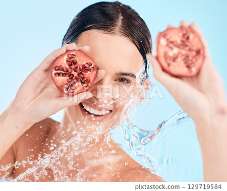 Portrait, skincare and pomegranate by woman in water splash for wellness, cleaning and skin health on blue background. Beauty, splash and fruit product by girl model smile for vegan facial in shower Portrait, skincare and pomegranate by woman in water splash for wellness, cleaning and skin health on blue background. Beauty, splash and fruit product by girl model smile for vegan facial in shower 129719584
