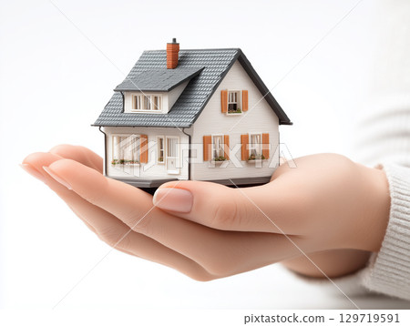 A model of a house in hand. Image material for planning your own home 129719591