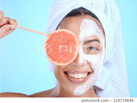 Woman, face mask and grapefruit skincare for beauty wellness portrait, natural cosmetics and luxury dermatology in studio. Model, facial spa care and vitamin c fruit nutrition, acne detox and glow 129719646