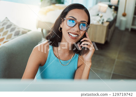 Working from home freelancer talking on phone while doing remote work on computer. Smiling, happy and motivated woman thinking, consulting and planning idea with communication and network for startup 129719742