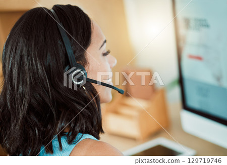 Call centre, customer service agent with a computer talking to customers, helping or answering calls in office. Closeup headshot of smiling, happy and friendly helpdesk operator and receptionist 129719746