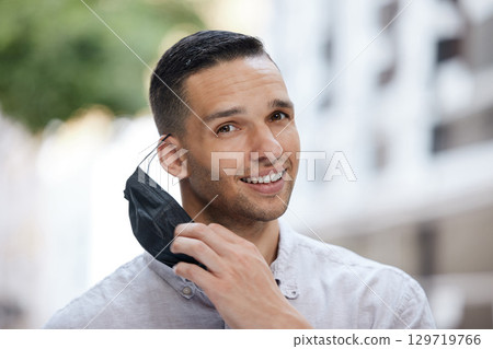 Taking off face mask, covid compliance portrait or man with motivation, happy smile or vision to stop global virus. Remove mask, post covid lockdown regulations and end of covid 19 pandemic disease Taking off face mask, covid compliance portrait or man with motivation, happy smile or vision to stop global virus. Remove mask, post covid lockdown regulations and end of covid 19 pandemic disease 129719766