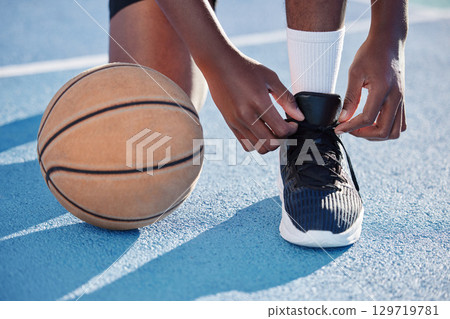 Fitness man on a court with a basketball for training, exercise and a workout by playing sports in athletic shoes. African athlete living a healthy, wellness and motivational lifestyle in summer Fitness man on a court with a basketball for training, exercise and a workout by playing sports in athletic shoes. African athlete living a healthy, wellness and motivational lifestyle in summer 129719781