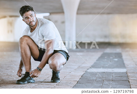 Fitness, running and exercise, a man going on a run in the city. Motivation, cardio and training, a runner lacing his sports shoes before an outdoor workout for a healthy body and an active lifestyle Fitness, running and exercise, a man going on a run in the city. Motivation, cardio and training, a runner lacing his sports shoes before an outdoor workout for a healthy body and an active lifestyle 129719798