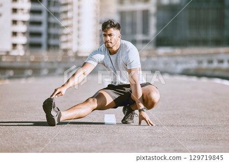 Fitness muscles stretching in city street, young man daily jogging and morning workout training. Physical warmup activity, healthy wellness coaching, sports practice and running for cardio exercise. Fitness muscles stretching in city street, young man daily jogging and morning workout training. Physical warmup activity, healthy wellness coaching, sports practice and running for cardio exercise. 129719845