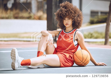 Confident female basketball coach with ball outside. Womens fitness motivation, workout, sports training and exercise wellness. Strong, powerful pro athlete posing for portrait on netball court. Confident female basketball coach with ball outside. Womens fitness motivation, workout, sports training and exercise wellness. Strong, powerful pro athlete posing for portrait on netball court. 129719856