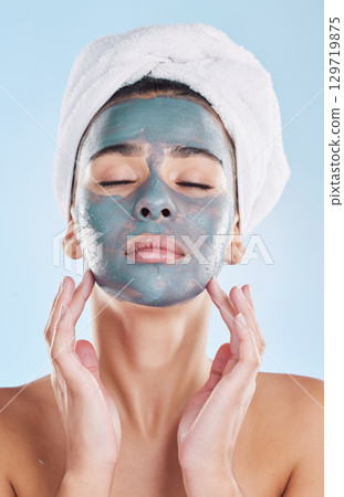 Skin, charcoal face mask and woman with morning self care routine, facial cleaning product and towel for hygiene skincare. Model with bathroom skin care beauty health on blue studio background mockup 129719875