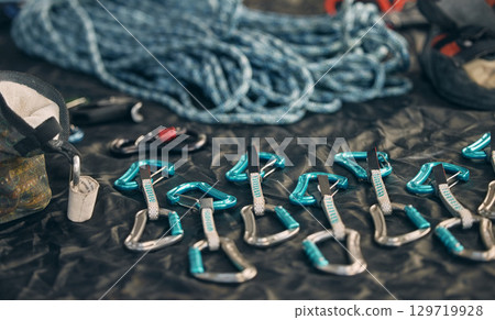 Rope safety, climbing and rock mountain sports equipment to be safe and secure. Sports tool setup zoom of carabiner an hook tools for an outdoor, security and adventure experience in the mountains 129719928