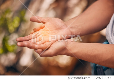 Hands, pain and active hand of a man hiking and suffering from a medical emergency outdoor. Healthcare, injury and fitness with a palm of a male highlighted with overlay and glow in nature Hands, pain and active hand of a man hiking and suffering from a medical emergency outdoor. Healthcare, injury and fitness with a palm of a male highlighted with overlay and glow in nature 129719932