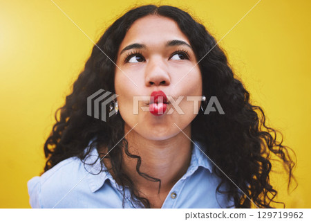 Black woman lips in kiss, red cosmetic lipstick and face closeup on yellow background. Retro aesthetic, young fashion model with funky pose thinking with cool beauty makeup on bright studio wall 129719962
