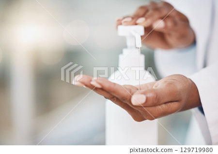 Healthcare, cleaning and covid rules at hospital by doctor disinfect hands with hand sanitizer. Compliance, safety and corona control by health expert closeup of good hygiene in fresh clean workspace 129719980