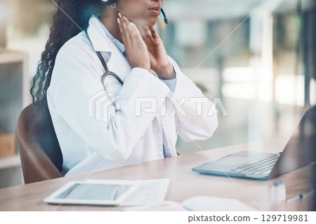 Doctor, explaining and online consultation using laptop for a virtual checkup for throat or covid while sitting in hospital office. Female medical insurance assistant on video call for telemedicine Doctor, explaining and online consultation using laptop for a virtual checkup for throat or covid while sitting in hospital office. Female medical insurance assistant on video call for telemedicine 129719981
