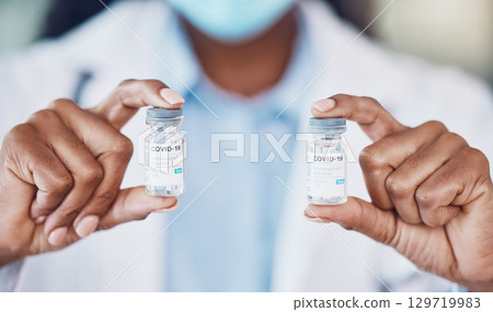 Doctor hands, covid vaccine medicine bottle and serum for risk, healthcare and wellness safety. Closeup corona virus medical worker, pharmaceutical innovation and scientist drug test cure of covid 19 Doctor hands, covid vaccine medicine bottle and serum for risk, healthcare and wellness safety. Closeup corona virus medical worker, pharmaceutical innovation and scientist drug test cure of covid 19 129719983