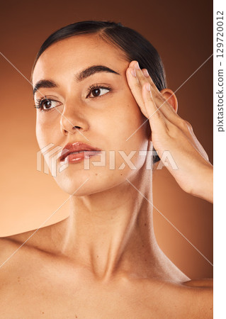 Woman, skincare and face in beauty cosmetics, makeup or facial treatment against a studio background. Beautiful female model posing in relax touching skin in cosmetic or perfect care on mockup Woman, skincare and face in beauty cosmetics, makeup or facial treatment against a studio background. Beautiful female model posing in relax touching skin in cosmetic or perfect care on mockup 129720012