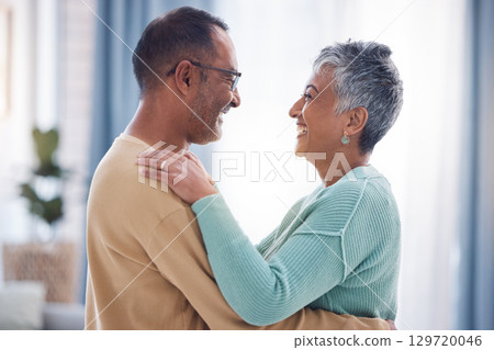 Happy, love and romance with a senior couple laughing, hugging or dancing together in their home. Dance, romantic and smile with a happy mature man and woman enjoying their retirement while bonding Happy, love and romance with a senior couple laughing, hugging or dancing together in their home. Dance, romantic and smile with a happy mature man and woman enjoying their retirement while bonding 129720046