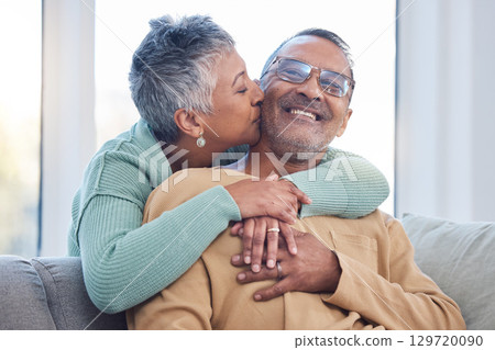 Marriage with couple, hug and kiss with love and commitment, quality time together at home and trust in relationship. Happy partner, care and strong bond, married senior woman and man with romance. 129720090