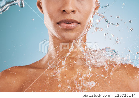 Water, cleaning and shower with a model black woman in studio on a blue background for hydration or hygiene. Relax, wellness and luxury with a water splash on a female in the bathroom for skincare Water, cleaning and shower with a model black woman in studio on a blue background for hydration or hygiene. Relax, wellness and luxury with a water splash on a female in the bathroom for skincare 129720114