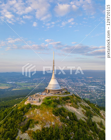 Jested Mountain Hotel stands tall against a vibrant sunset in Liberec. The modern design contrasts with the natural landscape, making it a perfect spot for evening visits and views. Jested Mountain Hotel stands tall against a vibrant sunset in Liberec. The modern design contrasts with the natural landscape, making it a perfect spot for evening visits and views. 129720115