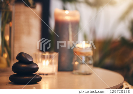 Stone, candle and spa with a still life objects on a table in a wellness center for aromatherapy to relax. Background, rock and luxury with stones and candles in a health salon for stress relief 129720128