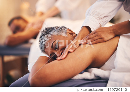 Couple at spa for massage, therapist hands and relax, wellness and holistic health with peace, zen and skincare. Beauty salon, luxury service with treatment and body care for calm and stress relief. 129720140