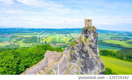 Trosky Castle ruins stand proudly on a rock formation, offering a panoramic view of the lush Bohemian Paradise landscape under a clear blue sky. 129720162