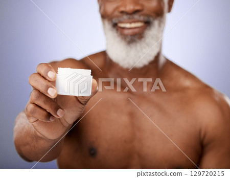 Beauty, skincare and product with a senior black man in studio on a purple background to promote body care. Happy, wellness and cosmetics with a mature male holding a container of moisturizer Beauty, skincare and product with a senior black man in studio on a purple background to promote body care. Happy, wellness and cosmetics with a mature male holding a container of moisturizer 129720215