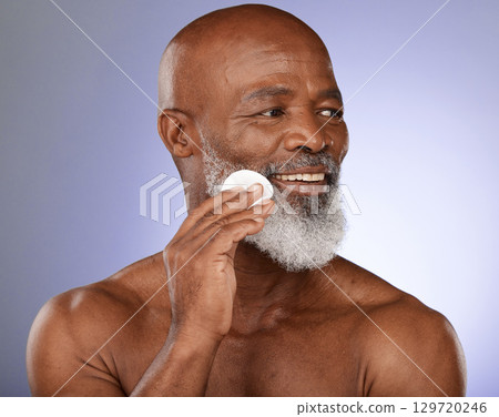 Face cotton, skincare and senior black man in studio on purple background. Beauty, wellness and elderly male model from Nigeria with facial pad or product for hygiene, cleaning and grooming beard. Face cotton, skincare and senior black man in studio on purple background. Beauty, wellness and elderly male model from Nigeria with facial pad or product for hygiene, cleaning and grooming beard. 129720246
