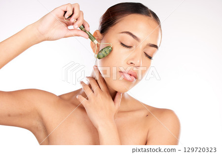 Beauty, skin and face with woman and roller cosmetic tool, skincare and cosmetics with glow and shine against white studio background. Facial massage, self care and wellness with cosmetology mockup. Beauty, skin and face with woman and roller cosmetic tool, skincare and cosmetics with glow and shine against white studio background. Facial massage, self care and wellness with cosmetology mockup. 129720323