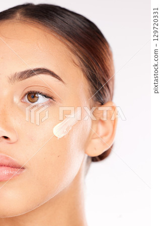 Skincare cream, half face and woman with beauty wellness, spa cosmetics and thinking against white studio background. Luxury product, facial moisturiser and model with sunscreen or dermatology lotion Skincare cream, half face and woman with beauty wellness, spa cosmetics and thinking against white studio background. Luxury product, facial moisturiser and model with sunscreen or dermatology lotion 129720331