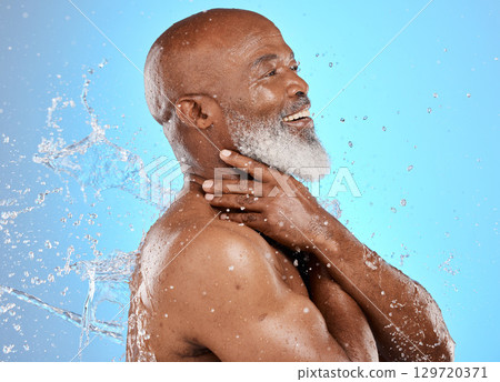Beauty, skincare and splash with black man and water for shower, hydration and hygiene. Cleaning, fresh and grooming routine with senior model for self care, cosmetics and luxury in blue background Beauty, skincare and splash with black man and water for shower, hydration and hygiene. Cleaning, fresh and grooming routine with senior model for self care, cosmetics and luxury in blue background 129720371
