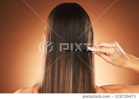 Beauty, hair care and comb for maintenace, combing and self care routine with growth, shine and repair shampoo on a gradient background. Back of female for health, wellness and hairstyle in studio Beauty, hair care and comb for maintenace, combing and self care routine with growth, shine and repair shampoo on a gradient background. Back of female for health, wellness and hairstyle in studio 129720473