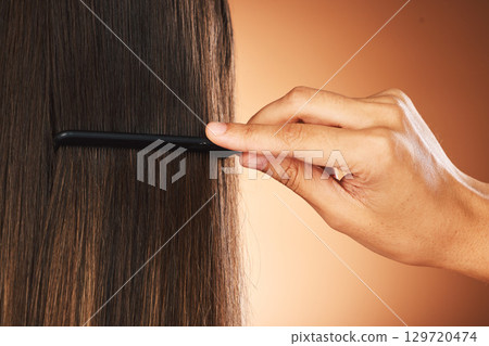 Hair care, back and hand with comb for beauty, growth and grooming in a studio background with mockup. Relaxed, texture and luxury hairdresser brushing a woman or clients healthy head at salon 129720474