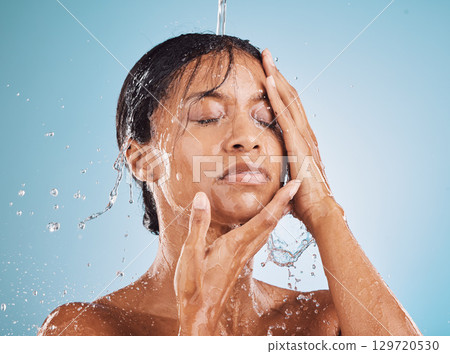 Skincare, beauty and water splash for cleaning, facial and wellness of skin, body and face on blue studio background. Aesthetic model for self care, dermatology and cosmetics for luxury skin Skincare, beauty and water splash for cleaning, facial and wellness of skin, body and face on blue studio background. Aesthetic model for self care, dermatology and cosmetics for luxury skin 129720530