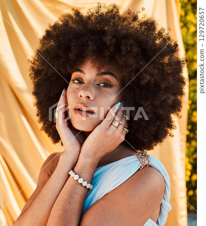 Summer, fashion and portrait of black woman in garden with natural beauty, cosmetics and makeup on face. Skincare, wellness and girl with yellow fabric or silk sheet outdoors and designer jewellery 129720657