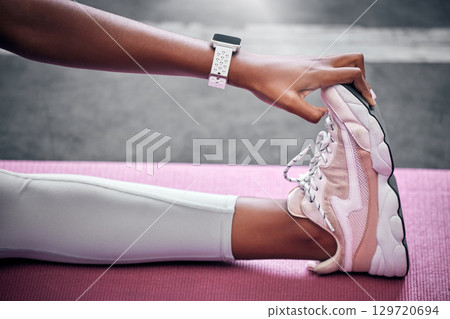 Fitness, feet and woman stretching, sneakers and legs on mat for sports training, exercise and yoga workout. Closeup of female athlete touching shoes, foot and warm up, wellness and healthy lifestyle 129720694